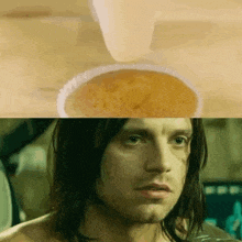 a close up of a man 's face next to a bowl of food