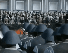 a group of soldiers marching in front of a crowd of people