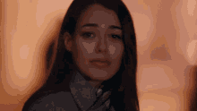 a close up of a woman 's face with her hair blowing in the wind