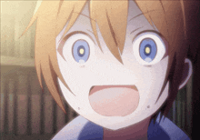 a close up of a child 's face with a surprised look on his face