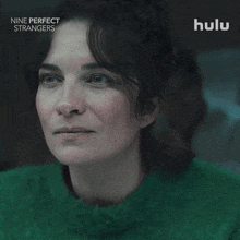 a woman in a green sweater is featured on hulu