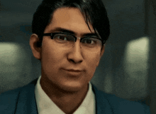 a man wearing glasses and a blue suit looks at the camera .