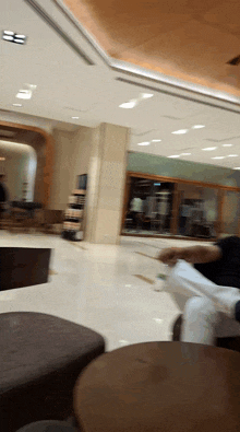 a blurred image of a person sitting in a lobby