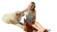 a woman sitting on the ground with a dog and chicken