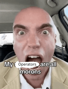 a bald man is making a funny face with the words my operators are all morons below him