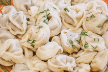 a close up of a plate of noodles with dill on top