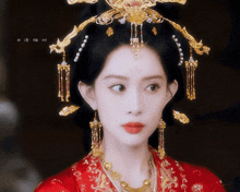 a close up of a woman wearing a red dress and a gold crown