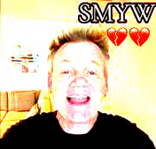 a man is smiling in front of a wall that says smyw