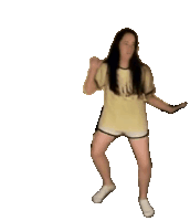 a woman wearing a yellow shirt and shorts is dancing