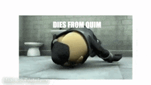 a cartoon character is laying on the floor in front of a toilet .