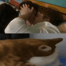 a couple kissing on a bed next to a cat with a hole in its ear