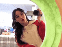 a woman taking a picture of herself in a mirror