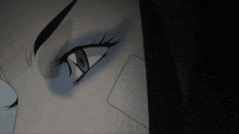 a close up of a woman 's eye with a shadow of a triangle on it