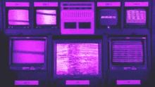 a bunch of televisions are sitting on a wall with purple lights on them .