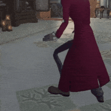 a person in a red coat is crawling on a tiled floor