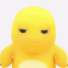 a close up of a yellow stuffed animal with green eyes making a funny face .