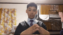 a young man in a suit and tie stands in front of bunk beds