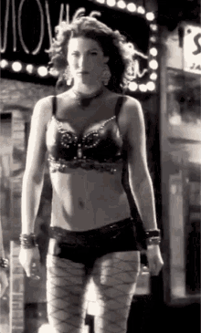 a woman in lingerie is standing in front of a sign that says ' ulove '