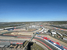 an aerial view of a race track with a red white and blue flag on the side