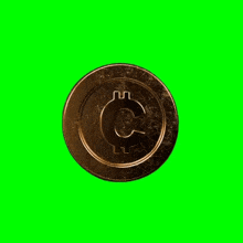 a gold coin with the letter c on it on a green screen