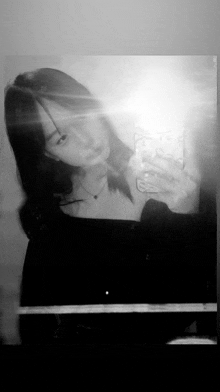 a woman is taking a selfie in a mirror .