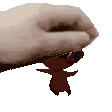 a hand is holding a small cartoon character in its fingers .