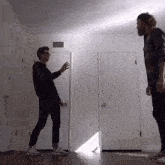 two men are standing in a room with a white door