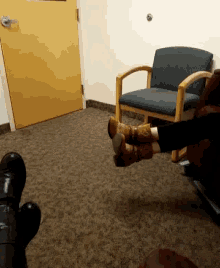 a person sitting in a chair with their feet on the floor
