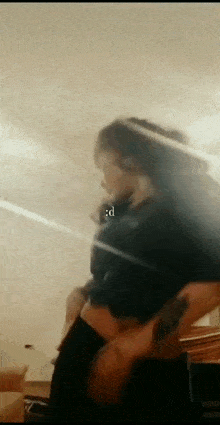 a woman is taking a picture of herself in the mirror .