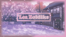 a sign that says les zoldiks in front of a cherry blossom tree