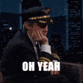 a man in a suit and tie wearing a pilot 's hat