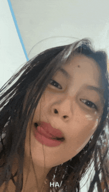 a close up of a woman 's face with the word ha written on the bottom