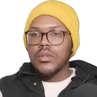a man wearing a yellow beanie and glasses