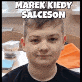 a young boy is sitting at a desk with the words marek kiedy salceson written above him