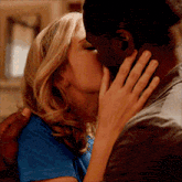 a man and a woman are kissing each other