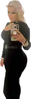 a woman taking a picture of herself with a phone