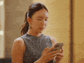 a woman is looking at her cell phone with justjaycee tumblr written on the bottom