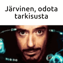 a close up of a man 's face with the words " jarvinen , odota tarkiusta " above it