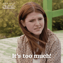 a woman says it 's too much in front of a green sign