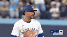 a blue jays player stands on the field during a game