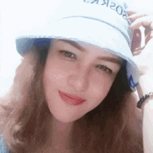 a close up of a woman wearing a hat that says ' a20b ' on it