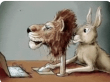 a lion and a rabbit are sitting at a table with a laptop .