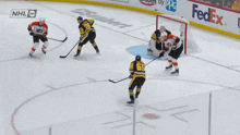 a hockey game is being played with advertisements for fedex and enterprise