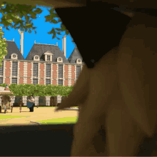 a blurry picture of a brick building with a few people walking in front of it