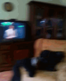a blurry picture of a person watching a tv