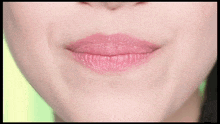 a close up of a woman 's lips with pink lipstick on them