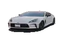 a white sports car is parked on the side of the road .