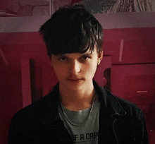 a young man wearing a gray shirt that says if a dare