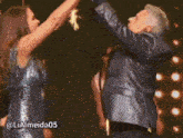 a woman in a sequined dress is dancing with a man in a leather jacket and the hashtag lialmeida05
