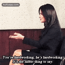 a woman is sitting in a chair with her legs crossed and talking to a man .